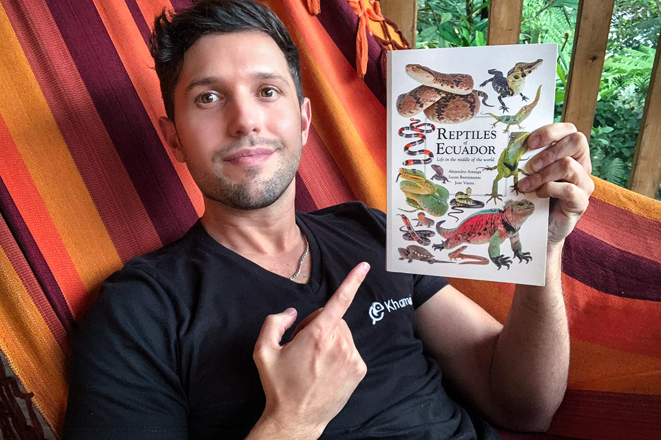 Alejandro Arteaga holding the Reptiles of Ecuador book