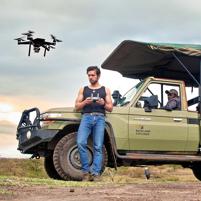 Alejandro Arteaga flying a drone in the savanna